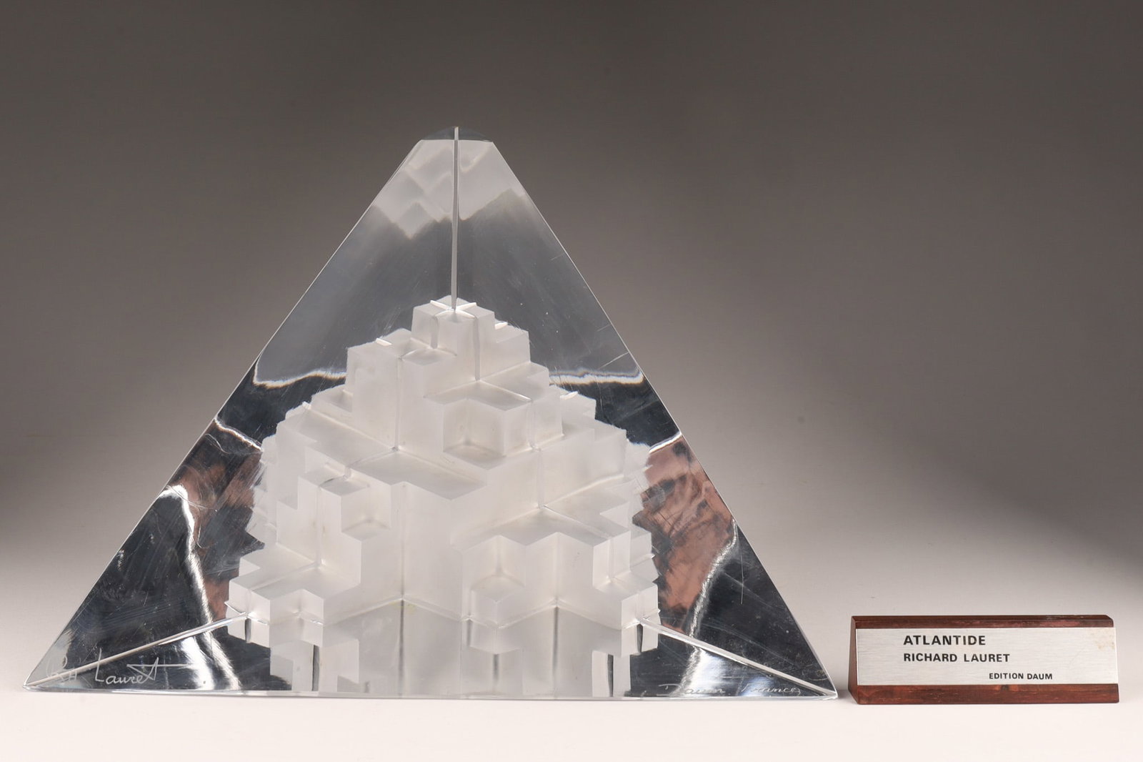 Richard Lauret Abstract Sculpture Atlantide Daum: Richard Lauret crystal pyramid sculpture Atlantide, made as a limited edition by Daum, France, numbered and signed on base. 8.5 inches H x 10.75 inches W. Comes with display name plate. Point of trian