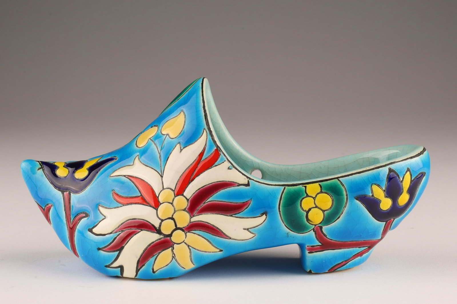 LONGWY French Faience Pottery Blue Floral Shoe: LONGWY French Faience Art Pottery Blue Floral Clog Shoe Sabot. 6 inches L x 2.5 H x 2.25 W. Marked under Made in France LONGWY.