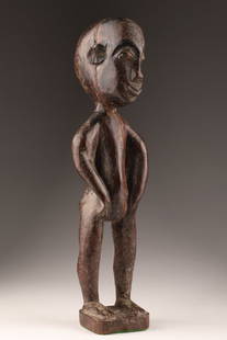 African Carved Singiti Hemba Ancestor Statue: An African, carved wood sculpture known as a Singiti Statue depicting a Hemba ancestor figure, most likely from Congo. These figures are used in rituals and are characterized by a smooth surface and d
