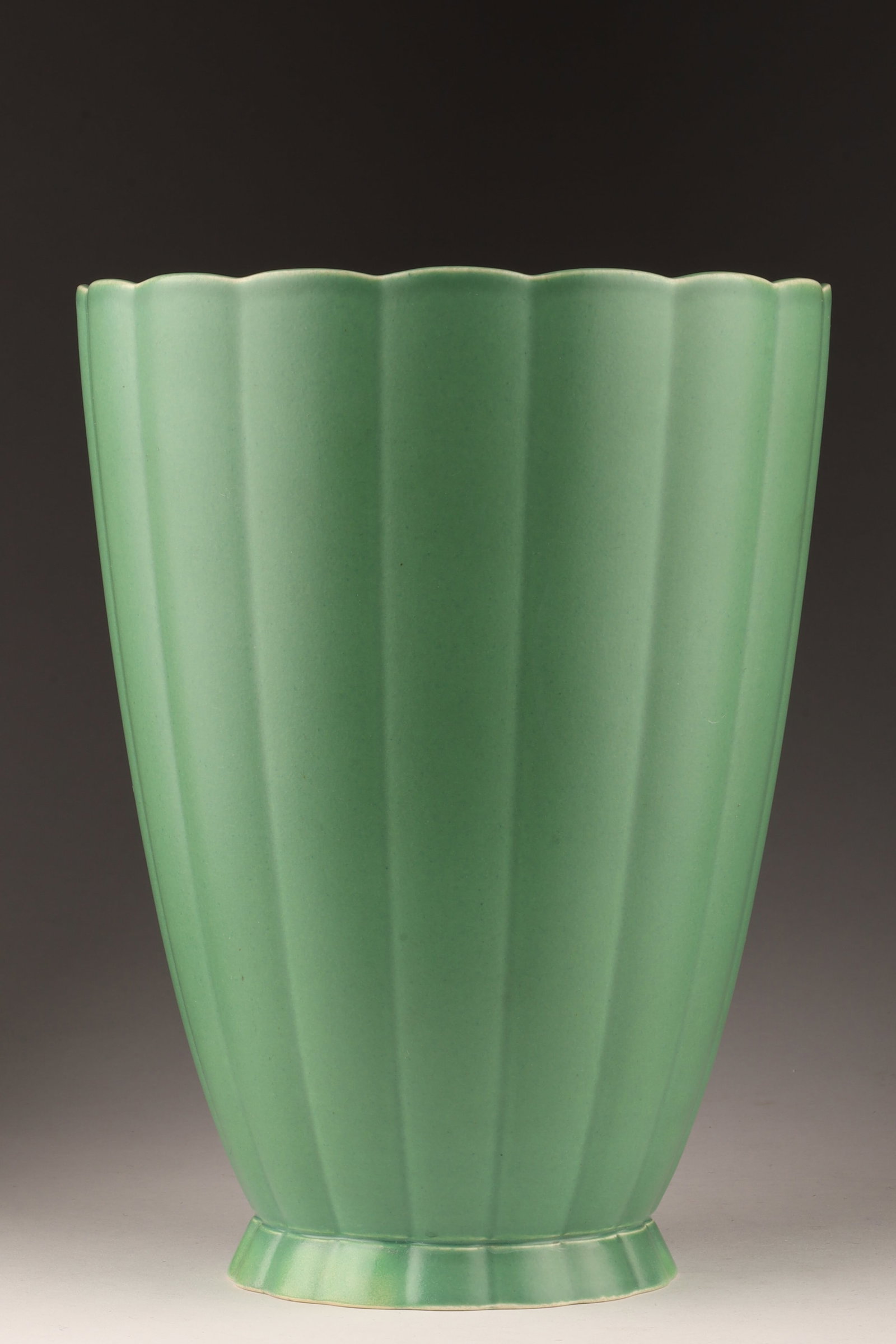 Large Keith Murray for Wedgwood Matt Green Vase: Large Fluted Matt Green Glazed Vase by Keith Murray for Wedgwood. 9.25 inches H x 7 W. Marked on base, made in England, impressed mark and written. Hairline filled and over painted, as shown.