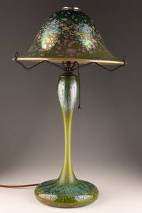 Phoenix Studios John Cook Chip Glass Table Lamp: Phoenix Studios John Cook Art Glass Table Lamp. Features iridescent green flared shade and body with a green, blue and brown chip pattern on a closed base. Etched mark John Cook Phoenix Studios under