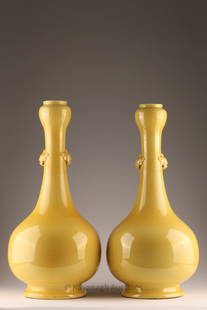 Large Chinese Yellow Garlic Mouth Bottle Vases: Pair of Large Chinese Yellow Monochrome Ground Garlic-Mouth Bottle Vases with long, cylindrical neck paired with mythical beast heads / masks. 22.5 inches H x 9.5 W