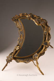 Victorian Aesthetic Brass Crescent Table Mirror: Decorated with birds, insects and folliage on a patinated and hand etched brass background, with a solid brass easel. 13 inches W x 17 H, 17 inches deep when standing.