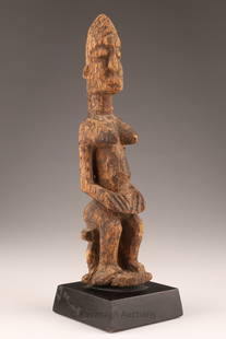 African Dogon Carved Wood Shrine Figure from Mali: A Tellem or Tellum Style Dogon carved wood shrine figure. 8 inches H, 9.5 inches H x 2.5 W with black base. Provenance: A Belgian Collection of African Art.