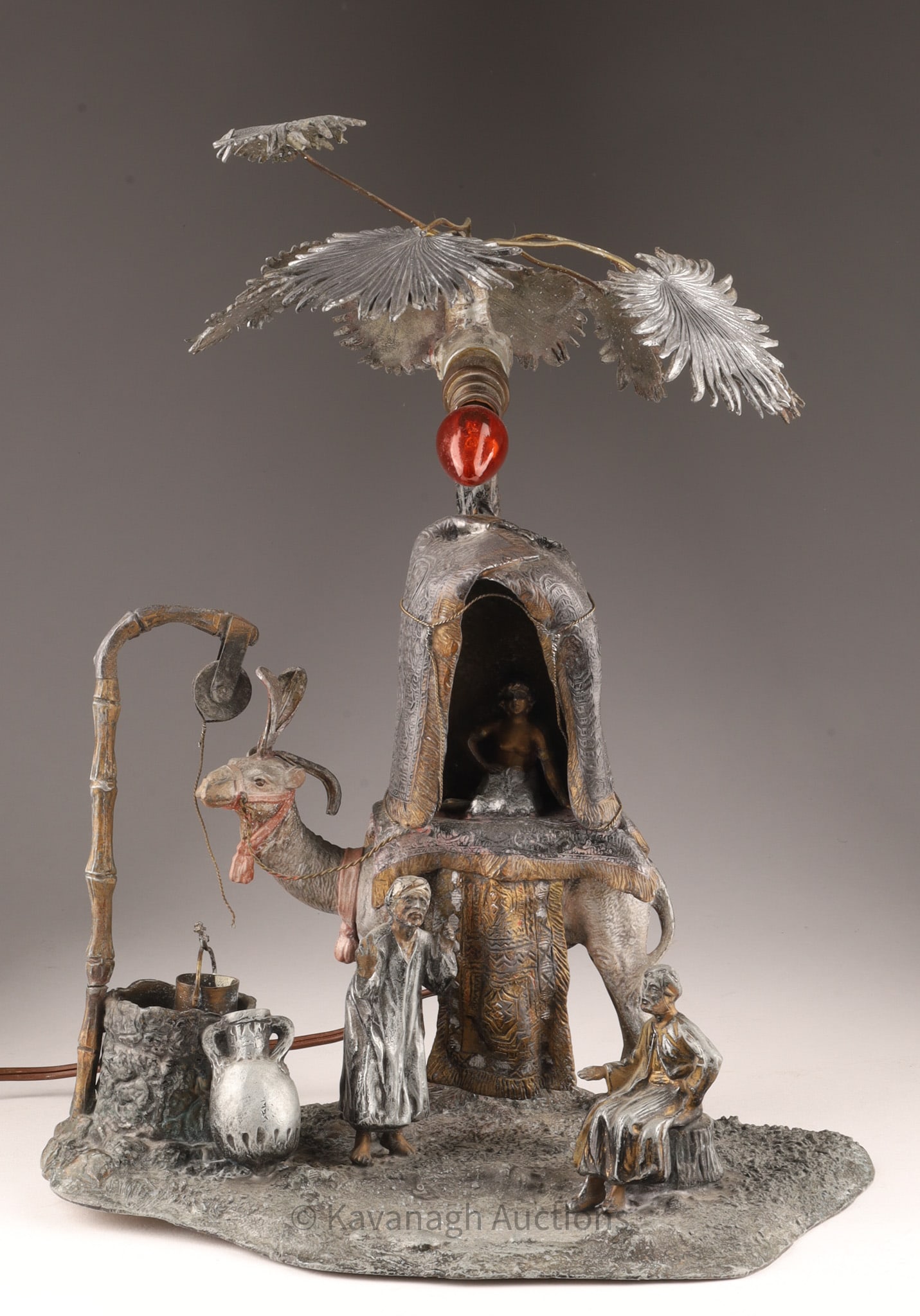 Spelter Art Nouveau Austrian Oasis Lamp: Spelter Art Nouveau Austrian Orientalist-style Oasis Lamp featuring a detailed scene with a camel adorned with a richly decorated howdah with a seated semi nude female figure and two male figures stan