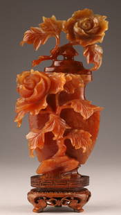 Chinese Carved Carnelian or Agate Floral Vase: Chinese Carved Carnelian or Agate Floral Vase, featuring intricate floral roses or peony motifs mounted on wood stand. Measuring 7.5 inches H x 3.5 W.