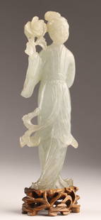 Chinese Finely Carved Jade Female Figure Guanyin: Chinese Finely Carved Jade Sculpture of a Female Figure or Guanyin holding a flower, mounted on to shaped wood base, measuring 7 inches H including stand, figure measures 6 inches H x 2 W.