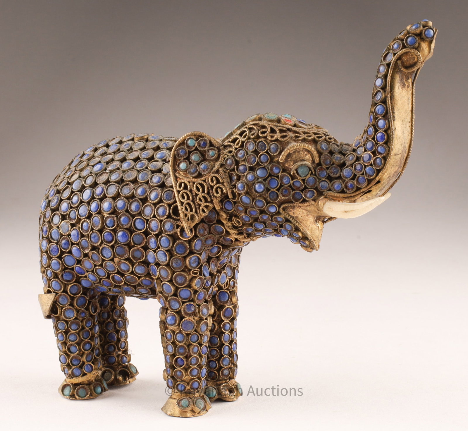 Nepalese Gilt Bronze Stone Decorated Elephant: Nepalese Gilt Bronze Stone decorated Elephant. 5.25" x 4.5" Missing stone on the left foot.