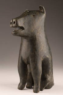 Inuit Carved Soapstone Animal Conlucy Niviaxie: Inuit Carved Soapstone Seated Animal Signed Conlucy Niviaxie (Port Harrison / Inukjuak, 1892-?) Disc Number E9-728. 7 inches H x 5 x 2.5 deep.