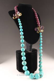 Iradj Moini New York Ruby Turquoise Statement Necklace: Iradj Moini New York matinee length statement necklace of large graduated turqoise beads and reddish purple melon carved genuine ruby beads, the two parts connected by butterflies set with amethyst an