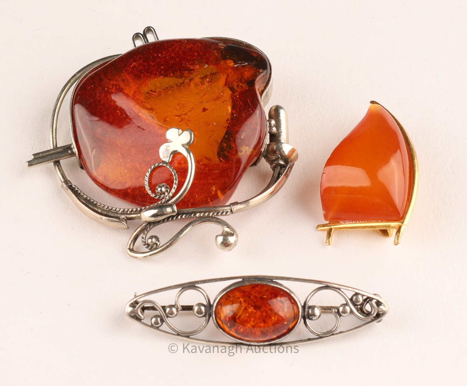 Lot Art Nouveau Art Deco Amber and Sterling Silver Brooches: Lot Art Nouveau Art Deco Amber and Sterling Silver Brooches, Russian gold tone amber brooch marked 5RK.Largest brooch measures 2 inches diameter.
