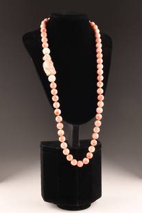 Angel Skin Coral Bead Necklace Carved Buddha: Angel skin coral large bead necklace with hand carved buddha figure set within, individually knotted beads. THIS ITEM CANNOT BE EXPORTED FROM CANADA33 inches L