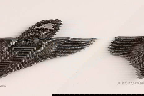 World War II Army Air Force Pilot Wings: World War II army airforce pilot or navigator wings, the spread wings set in the middle with a shield marked PS, below a laurel wreath containing a lion passant.3 inches W x 1.5 H
