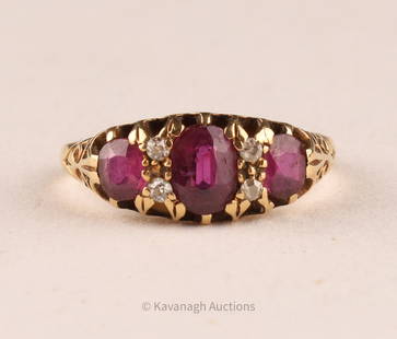 An 18K Gold, Ruby and Diamond Ring: An antique ruby and diamond ring, made of 18kt yellow gold, featuring three oval cut rubies. Largest 6 x 4.5mm. Also set with four simple cut round diamonds. Size of ring: 6.5.