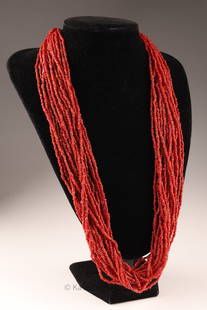 A Coral Multi-strand Torsade Bead Necklace: A multi-strand coral, polished bead necklace on silver-toned clasp.. THIS ITEM CANNOT BE EXPORTED FROM CANADATotal length of 22 inches.