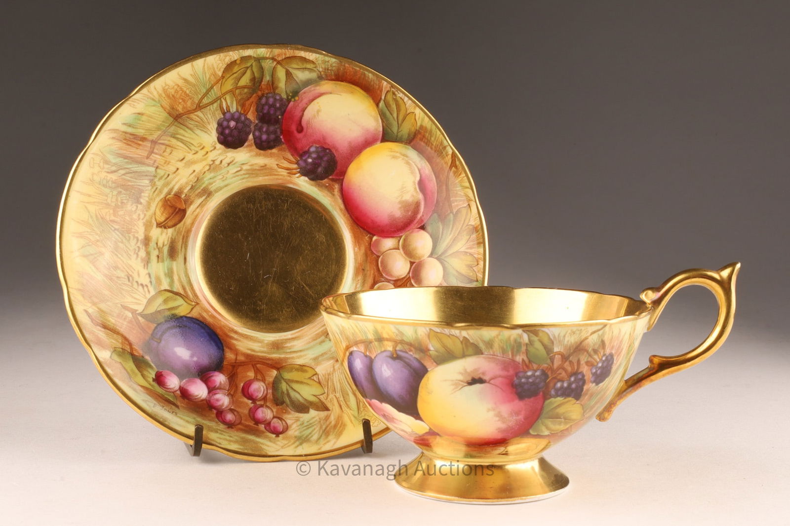 Aynsley Orchard Gold Tea Cup and Saucer Signed D. Jones: Aynsley Orchard Gold Tea Cup and Saucer Signed D. Jones.. Cup measures 5 inches W including handle x 2 H, Saucer 5.75 inches diameter.