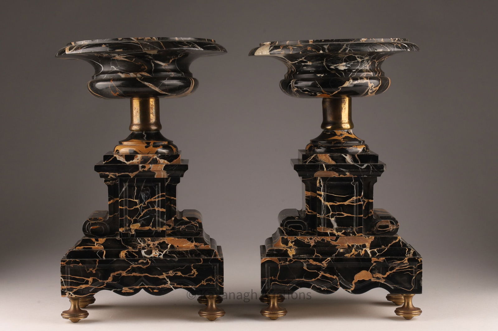 Pair of Antique Portoro Marble Tazzas Garnitures: Pair of Antique Portoro or Portor Black Marble Tazzas / Garnitures.. 12 inches H x 7 W x 7.5 deep. Loss to side of one tazza (replaced with faux marble), some small chips to marble. Full top rebuild t