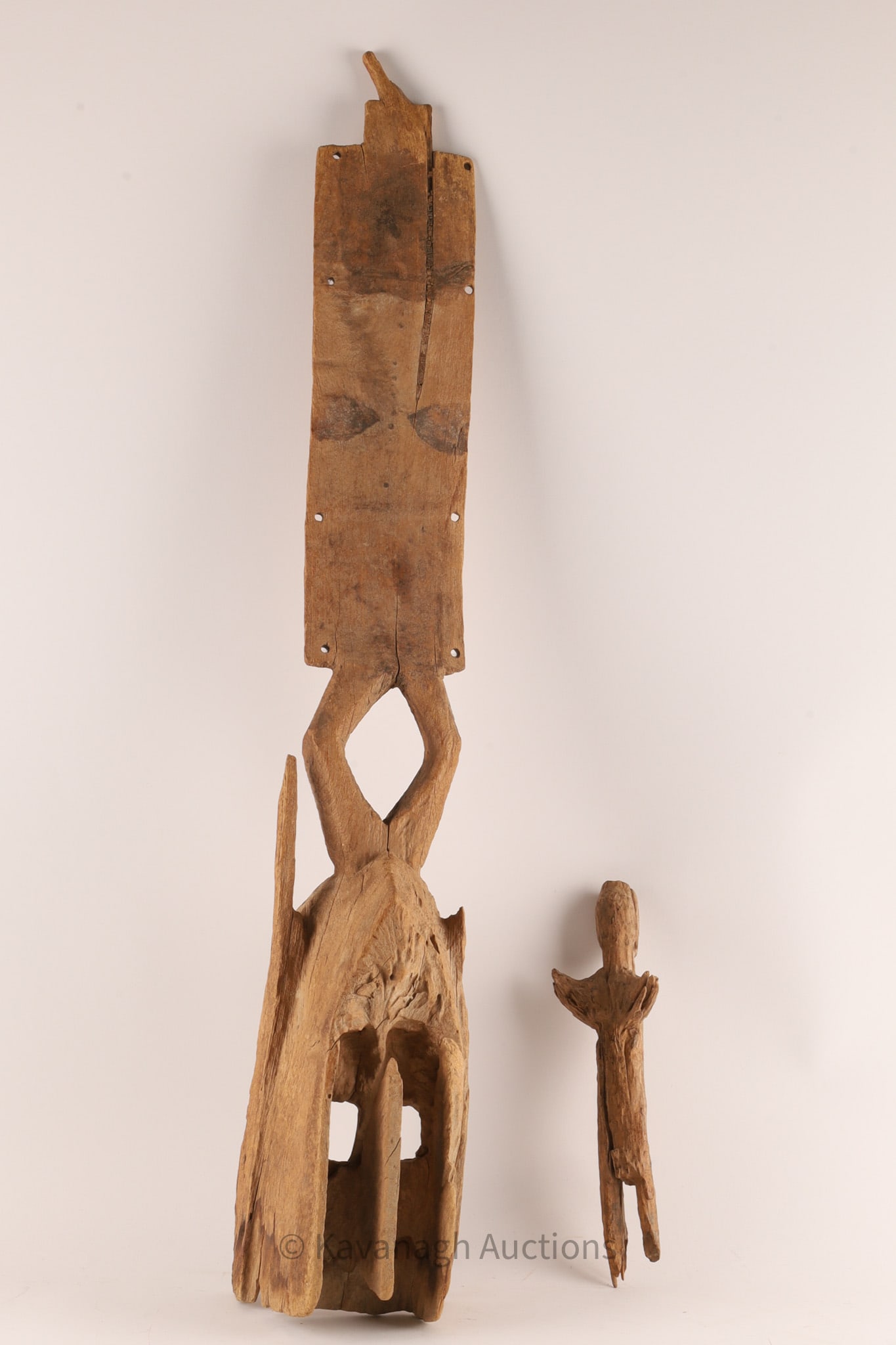 Lot of Antique Ivory Coast Fetish and Mask: Lot of Antique Ivory Coast Wood Carved Fetish and Mask. Mask measures 33 inches L x 5 W. Fetish measures 10 inches L. Wear and damage from suspected environmental erosion. 