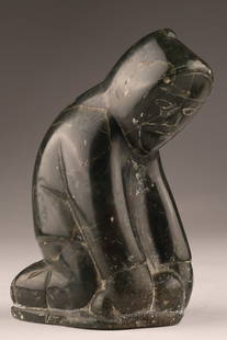 Inuit Soapstone Serpentine Carving, Kneeling Figure sculpture: A small Inuit carving of a kneeling figure in dark serpentine, with hooded parka and incised facial features. Retains the original Canadian Eskimo Art igloo tag to the underside. The base is further