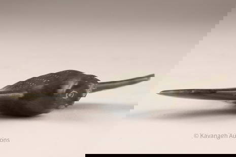 Inuit Soapstone Carving Bird in Flight: Carved in dark green-black soapstone, this small Inuit sculpture depicts a stylized bird in flight. The figure is finely polished, with incised details across the wings creating the suggestion of