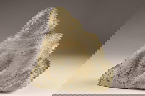 Annie Novalinga (Inuit, b. 1939) Stone Carving of a Seated Figure: Serpentine carving depicting a seated figure with head bowed and arms drawn closely to the body. The mottled grey-green stone shows natural inclusions, with light surface wear and handling marks