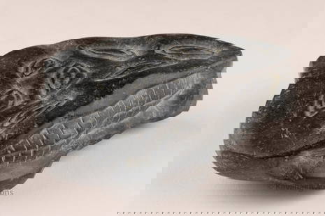 Inuit Carved Stone Sculpture, Abstract Shaman Design, Early Form: A small Inuit carved stone sculpture, measuring approx. 3.5 inches. The piece is decorated with incised motifs-repeated almond/eye-shaped forms and a cross-hatched element, possibly referencing