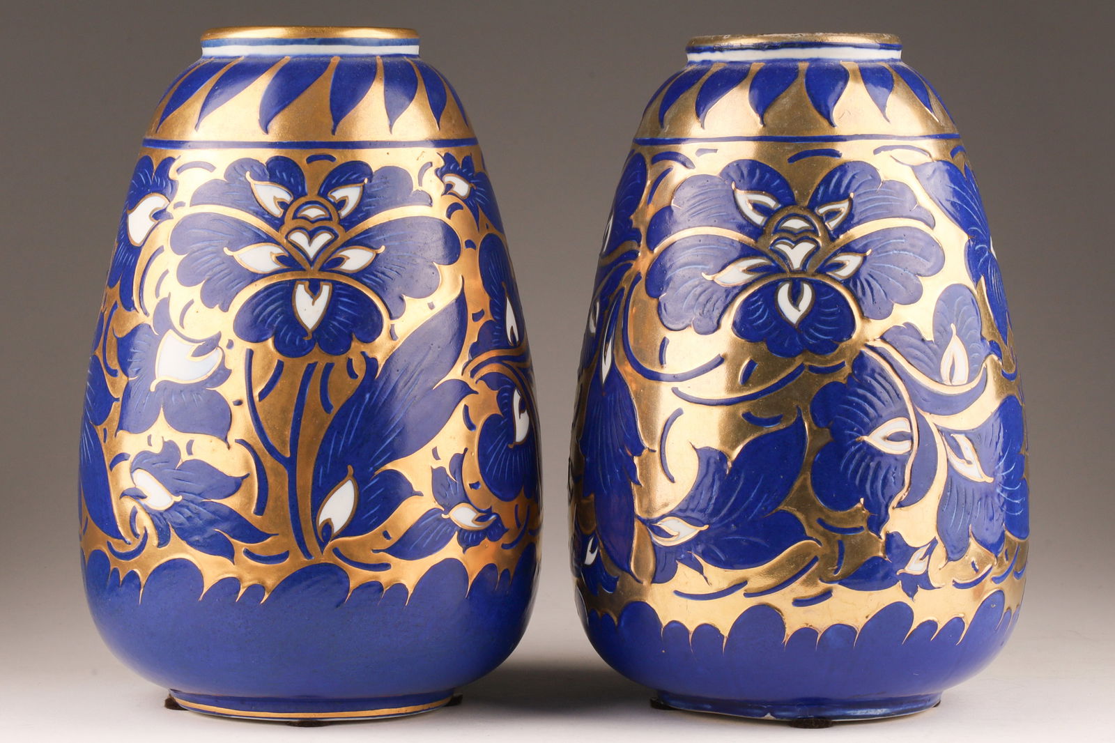 Pair Frederick / Charlotte Rhead Bursley Ware England Vases: Pair Frederick / Charlotte Rhead Bursley Ware England Vases, gold ground with cobalt blue flowers with white centres. Marked on underside, 649. Measuring 8.25”H x 5”W.