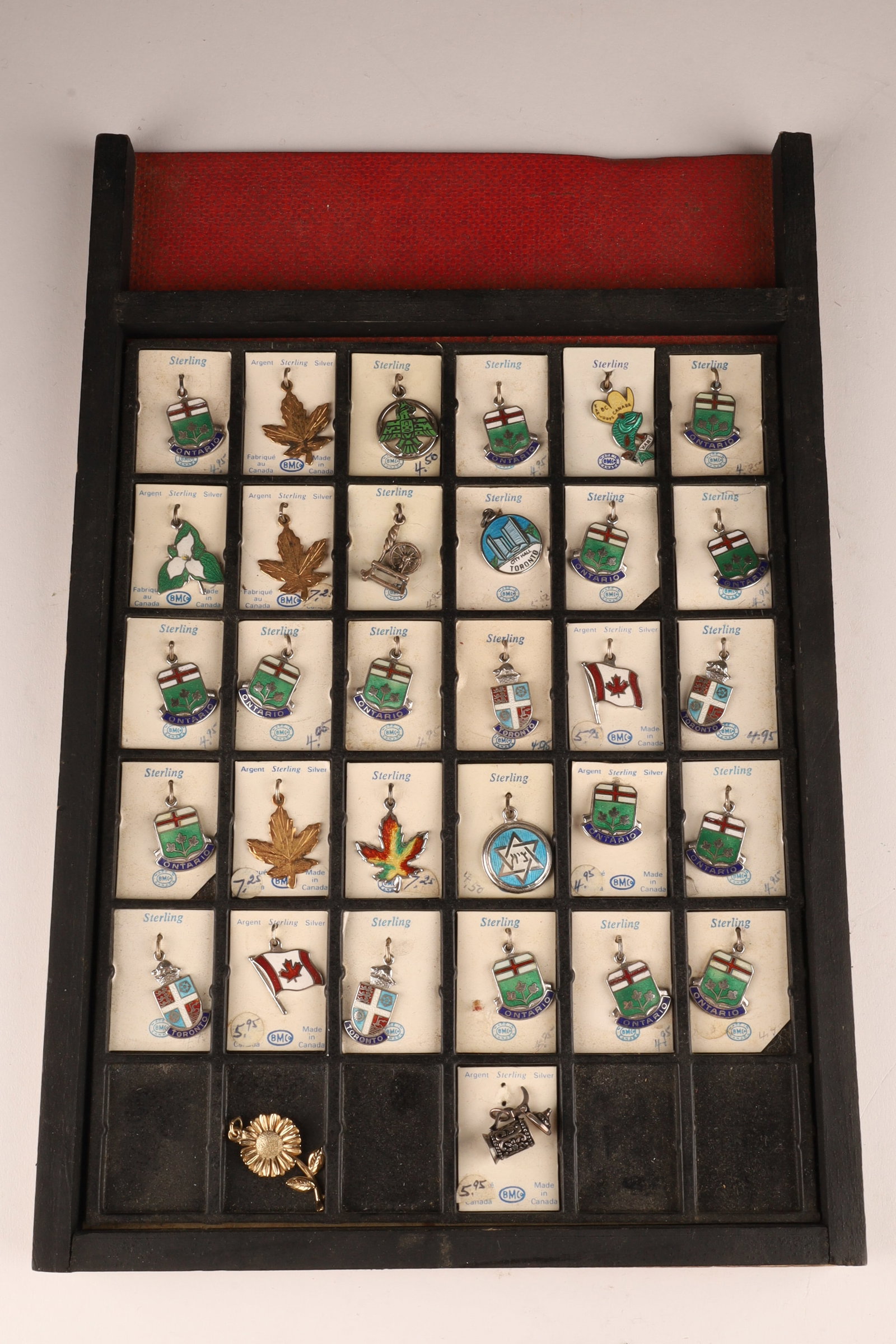 Lot of 32 Sterling Silver Canadian Charms: Mint on card - stand 11.75 x 7.75 - average length 0.75 inches including bail. Marked on cardboard, BMCo Made in Canada, Sterling.