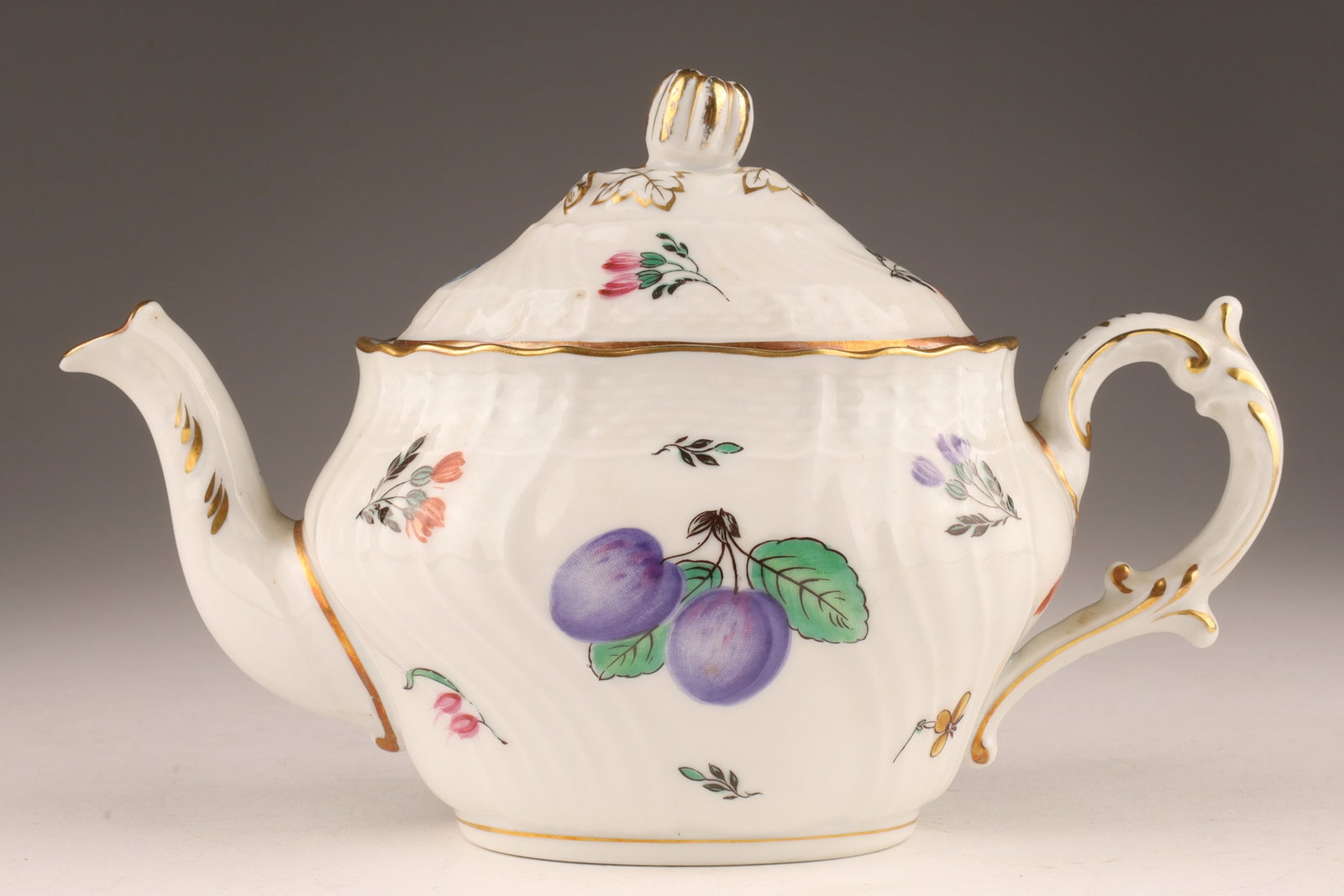 Richard Ginori Italian Porcelain Fruit Tea Pot: Richard Ginori Italian Porcelain Fruit Tea Pot. Decorated with scattered fruit and gilt decoration. Small chip to underside of lid, measuring 4.5”H x 7”W.
