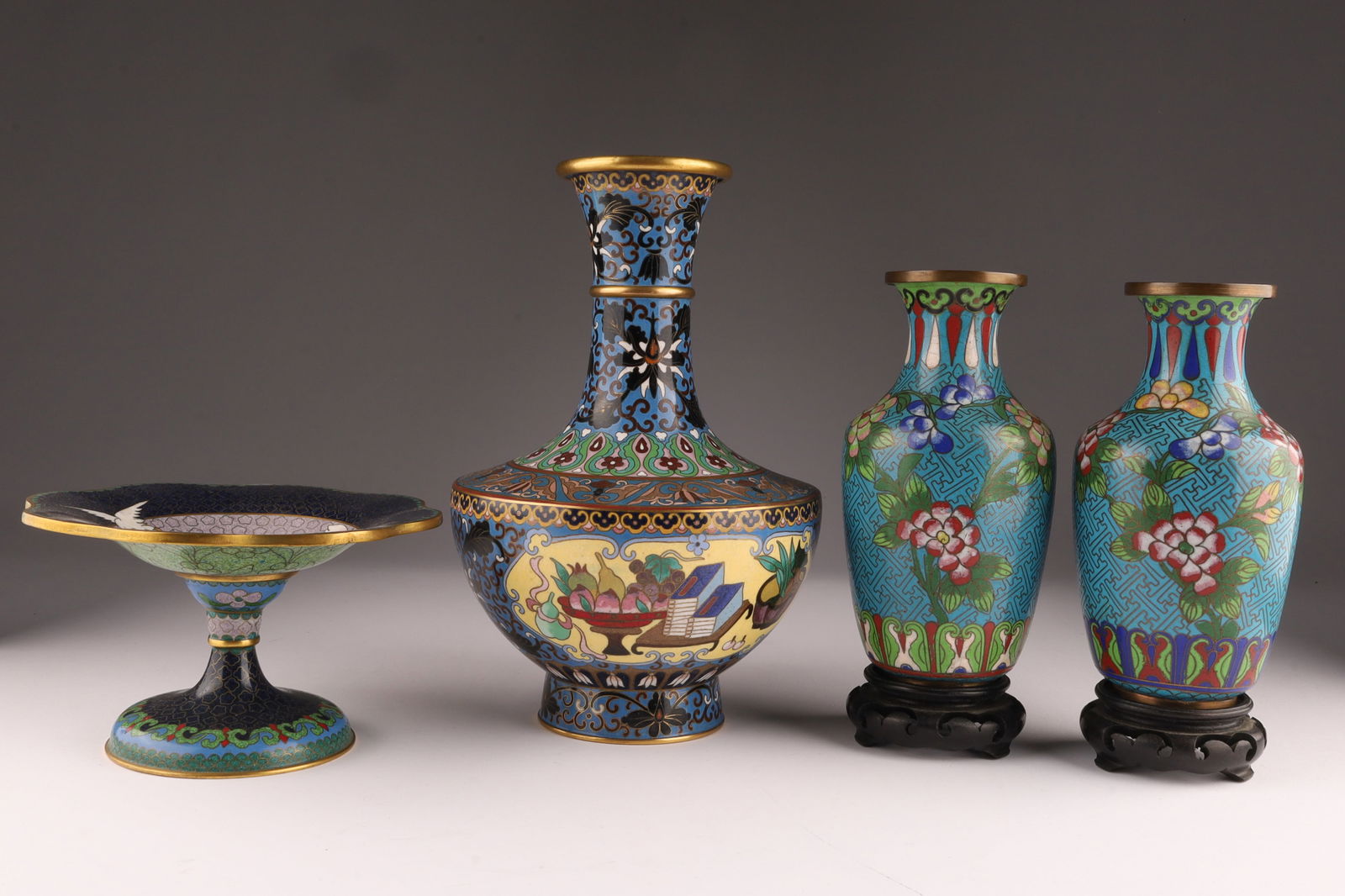 Lot of Four Chinese Cloisonne Vases: Lot of 4 Chinese Cloisonne Vases and compote. Largest measures 9.5 inches H x 6 W. Compote measures 3.5 inches H x 6.25 W. Pair of vases have some loss, dents along bottom, 6.5 inches H x 3.5 W withou