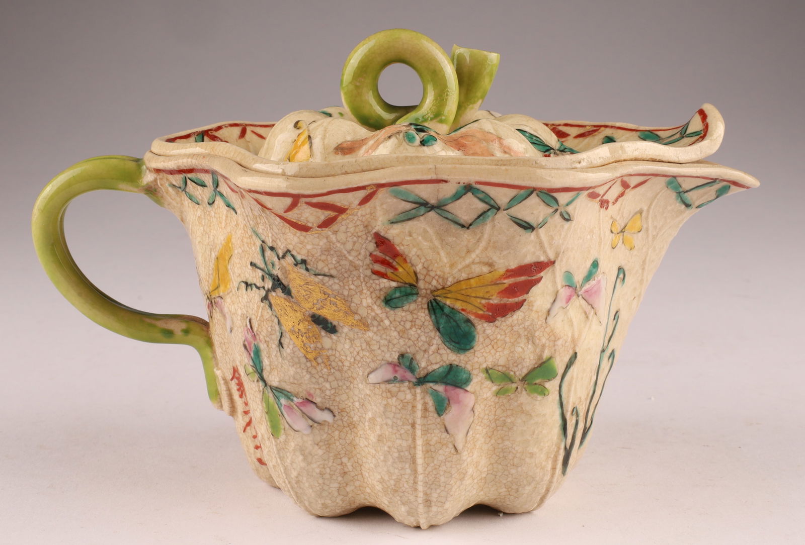 19th C Japanese Glazed Earthenware Teapot Signed: 19th C Japanese Glazed Earthenware Lotus Forn Teapot Signed, decorated with butterflies , signed with impressed raised plaque as well. Measuring 6 inches L x 4 H.