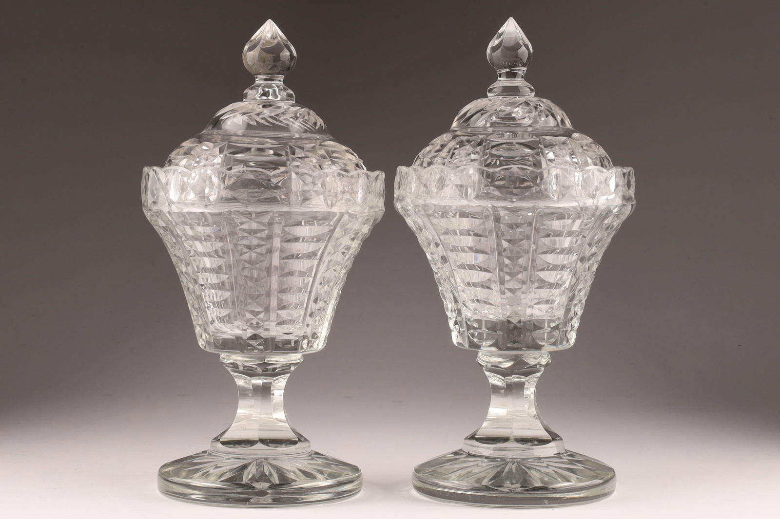 Pair Antique Georgian Anglo-Irish crystal sweet meats c.1810: An antique pair of cut crystal sweetmeat urns or conserve jars. 10.5 inches H 5 W. Some Small fleabites as shown.