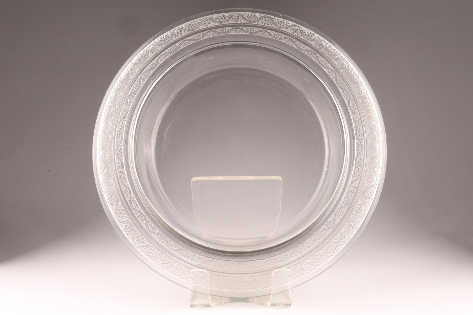 R. Lalique Frosted Glass Bowl with Grapes Motif: Rene Lalique 'Riquewihr' bowl clear glass with a double ringed elevated grapes motif frosted rim, and an acid etched mark 'R Lalique France' to the base. Created around 1935, these bowls are part of t