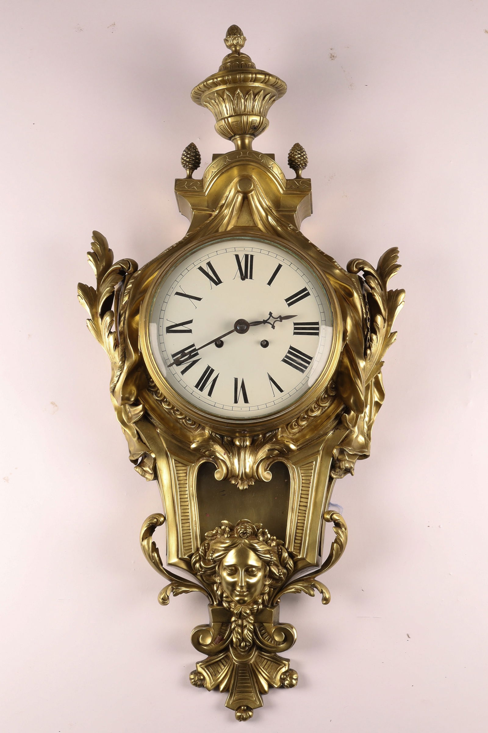 Large French Antique Louis XVI Ormolu Cartel Wall Clock in the Rococo Style: Large French Antique Louis XVI Ormolu Cartel Wall Clock in the Rococo Style, featuring an enamel dial with black Roman numerals and masks. Measuring 34 inches H x 14 W.
