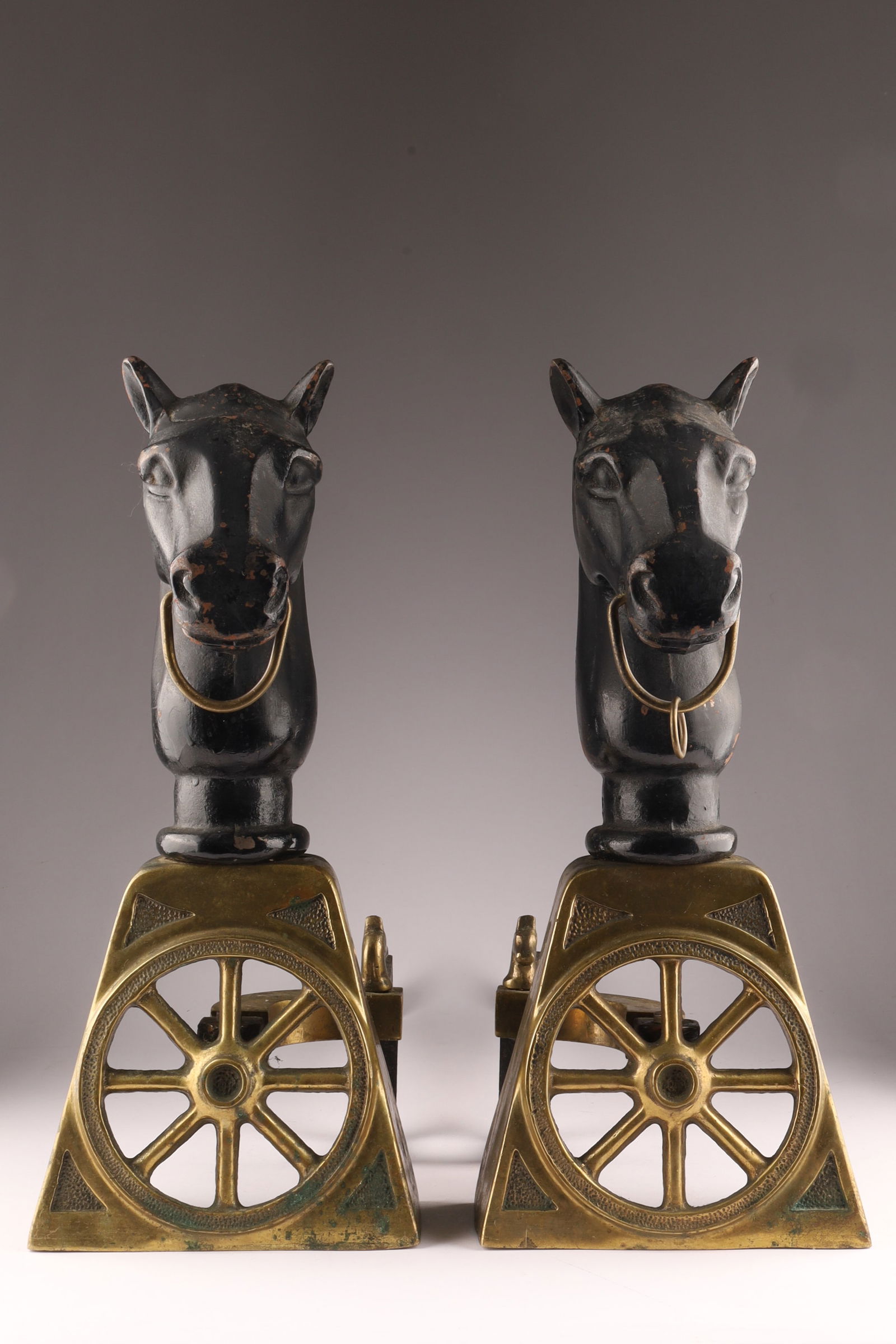 Pair of American Brass and Cast Iron Horse Head Wagon Wheel Andirons: Pair of American Brass and Cast Iron Horse Head Wagon Wheel Andirons. Measures 17.5 inches H x 8 W x 24 deep.