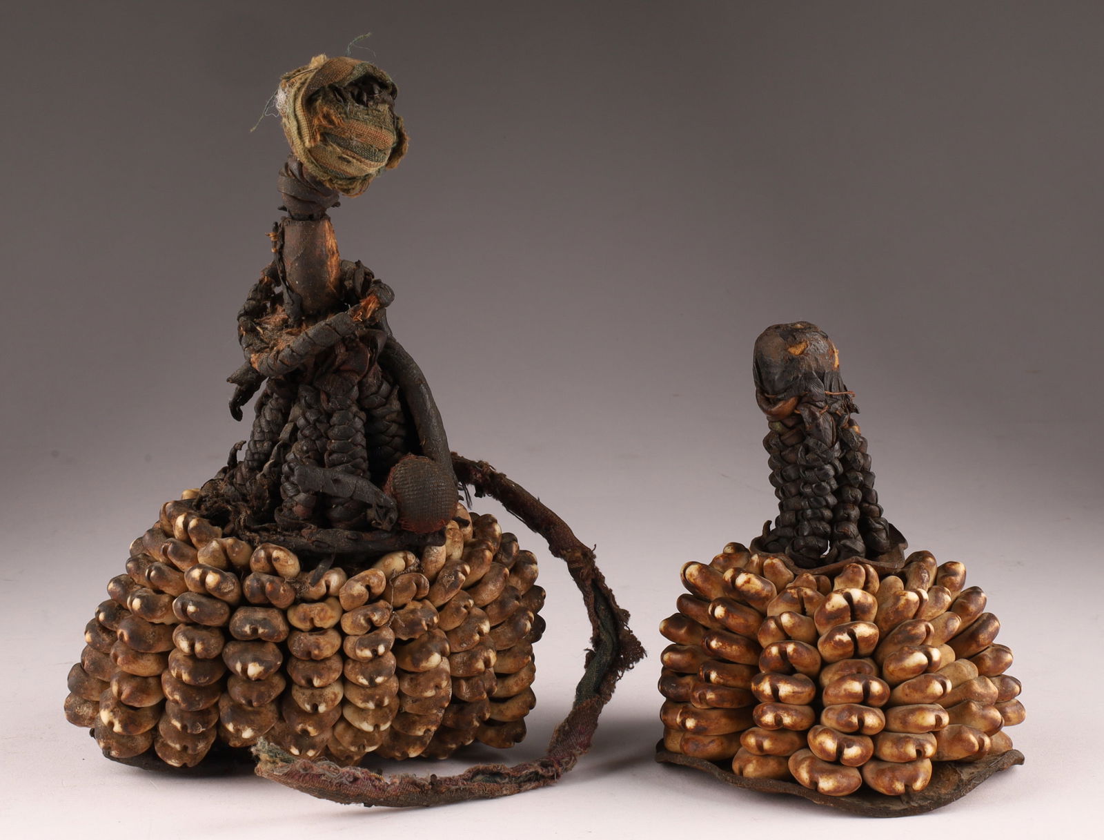 Lot Antique African Benin Yoruba Cowrie Shell and Leather Ritual Ibori / Ori Inu: Lot of 2 Antique African Benin Republic Yoruba Cowrie Shell and Leather Ritual Ibori / Ori Inu. Larger measuring 6.5 inches H x 4 W, smaller measures 4 x 3 inches.