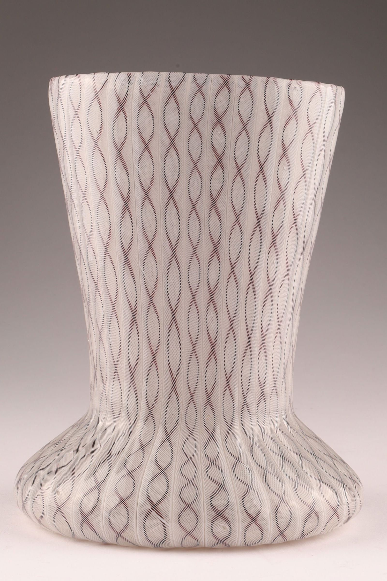 MID-CENTURY VENINI Murano Latticino Glass Vase, White Honeycomb: Produced in the 1950s, this Venini vase features distinct latticino network patterning and bears the Venini acid mark. Measuring 7 inches H x 5.5 W. From the collection of a prominent glass collector