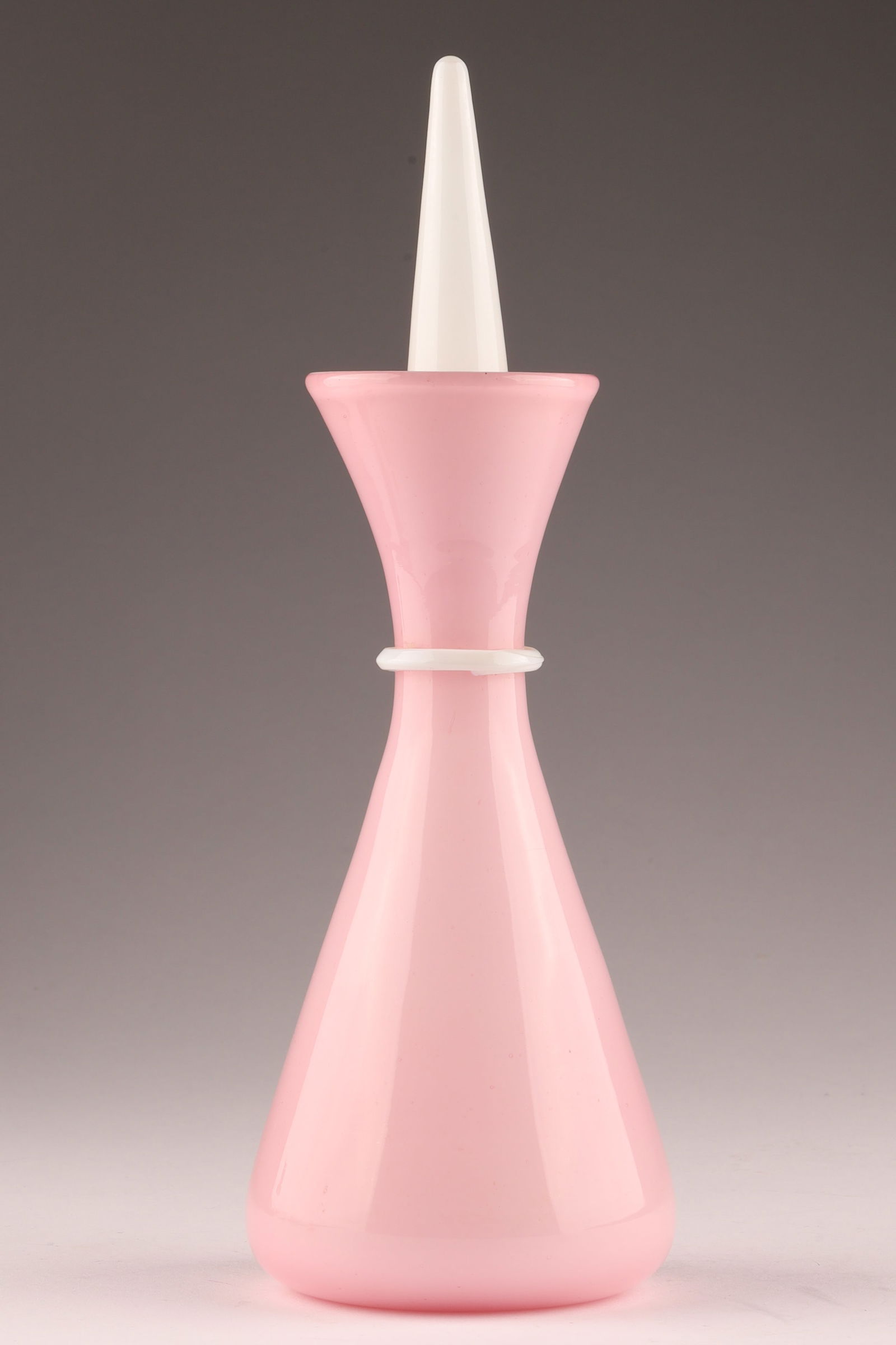 VENINI Attributed TOMASO BUZZI Vanity Bottle, Pink Glass: Attributed to Tomaso Buzzi, this Venini vanity bottle is an elegant example of 1930s Italian glass. Measuring 9.5 inches H x 3 W. Remnant of old sticker. From the collection of a prominent glass