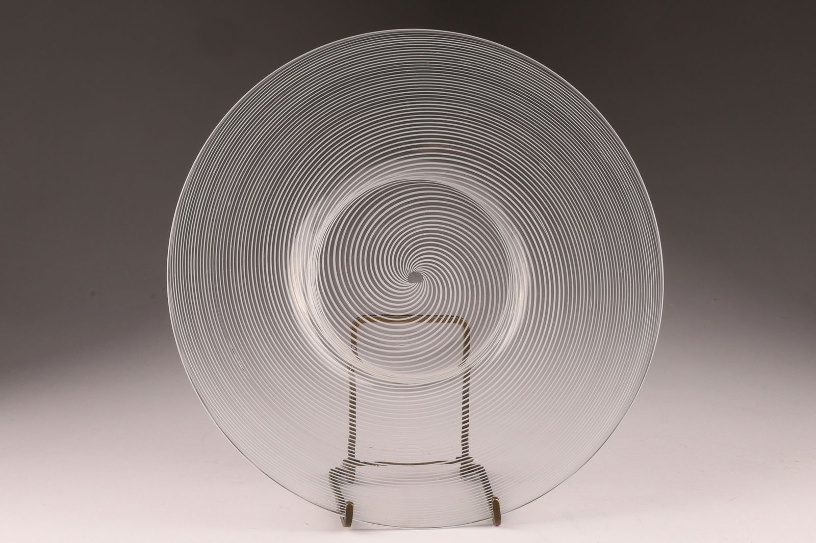 VENINI Murano Mezza Filigrana Small Glass Plate: This Venini plate features the mezza filigrana technique with a subtle concentric design. Measuring 7.75 inches diameter. From the collection of a prominent glass collector from Toronto.