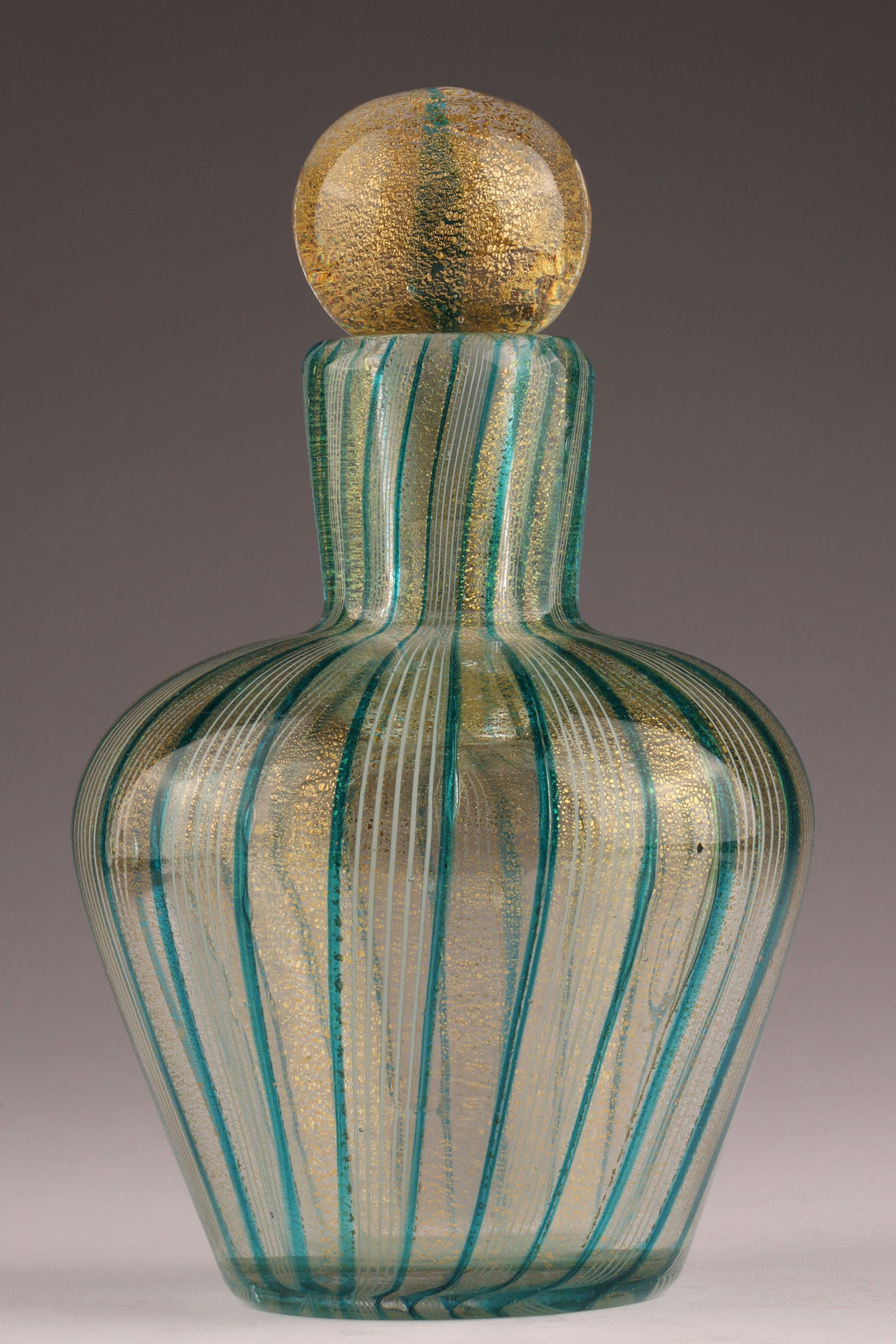 BAROVIER & TOSO Murano Striped Glass Perfume Bottle: This Barovier & Toso perfume bottle dates to the 1950s and is decorated with blue and gold stripes. Measuring 7 inches H x 4 W. From the collection of a prominent glass collector from Toronto.