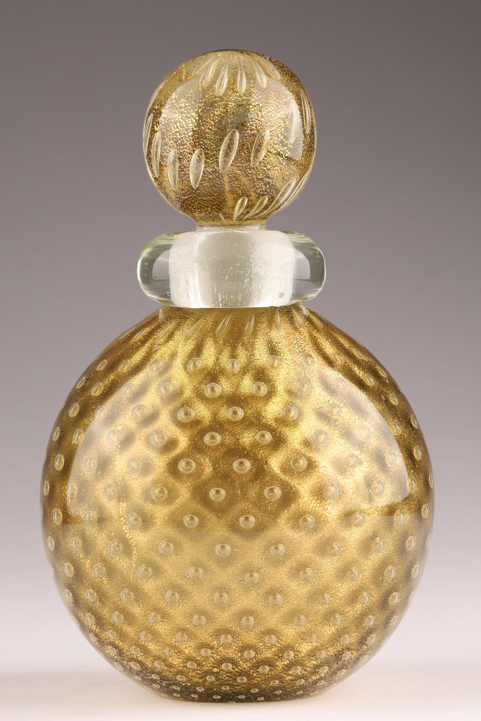 ARCHIMEDES SEGUSO Murano Textured Glass Perfume Bottle: This Archimedes Seguso perfume bottle dates to the 1950s and is decorated with gold inclusions covered by a controlled bubble net, measures 6 inches H. From the collection of a prominent glass collect