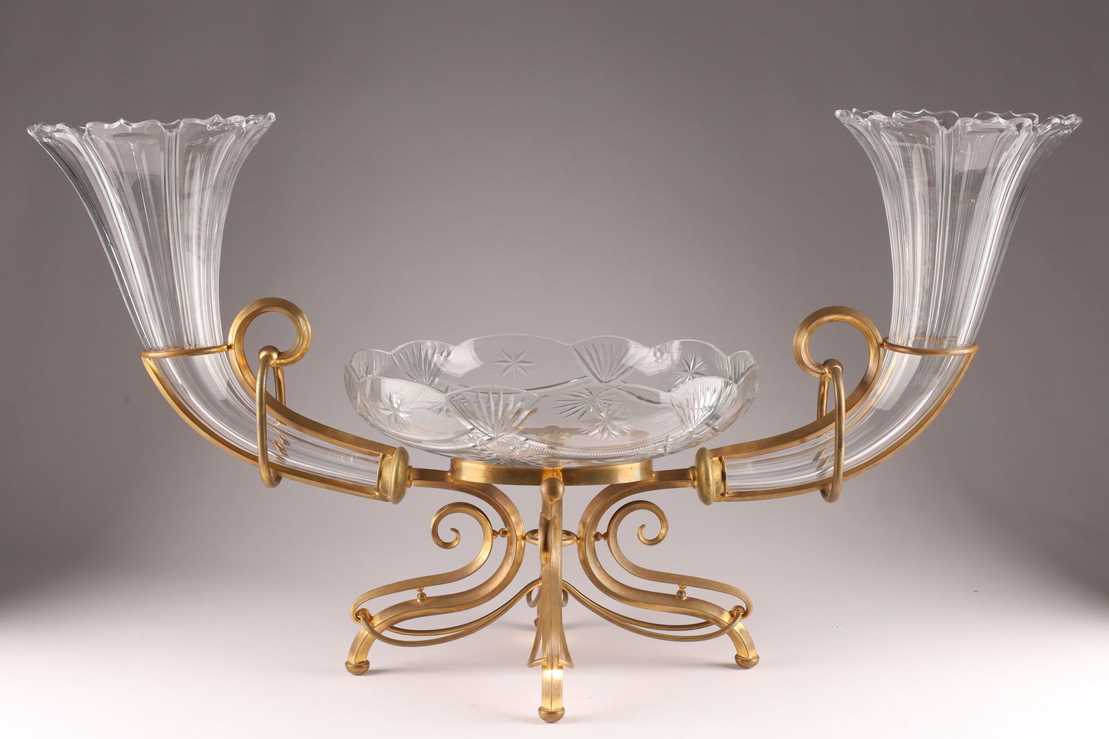 Antique Gilt Bronze and Glass Centrepiece and Epergne: Antique Gilt Bronze and Glass Centrepiece and Epergne. Gilt bronzebase houses a glass bowl and two epergne style flower vases. Possibly from Baccarat. Measuring 18 inches H x 32 W x 14 deep.