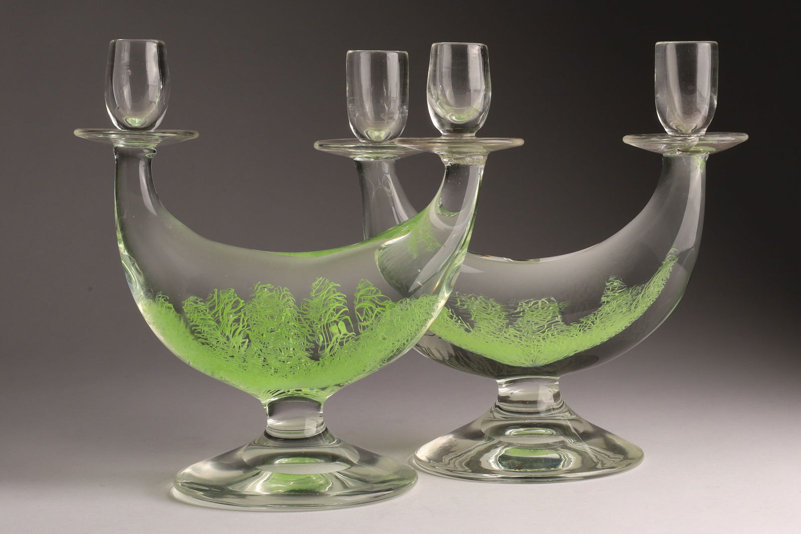 Pair Archimede Seguso Italian Art Glass Merletto Candlesticks: Pair Archimede Seguso Italian Art Glass Merletto Candlesticks, clear with pale green seaweed style caning. Double candlesticks, one with staple repair. 8.5 inches H x 8.5 W x 4.5 deep.