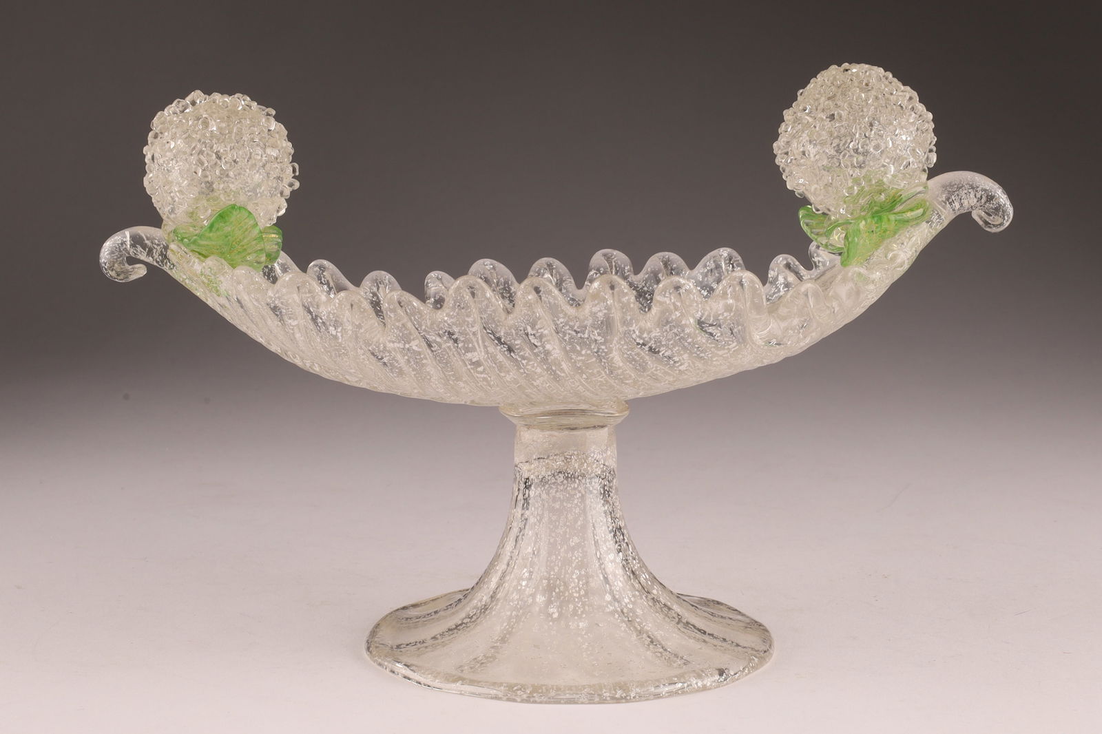 Barovier and Toso Italy Art Glass Footed Dish with Applied Leaves and Pompoms: Barovier and Toso Italy Small Footed Leaf form Dish with Avventurina Silver Flecks, Applied Green Leaves and Pompom Style Accents. Restoration to one tip, measuring 8 inches W x 5 H x 4 deep.