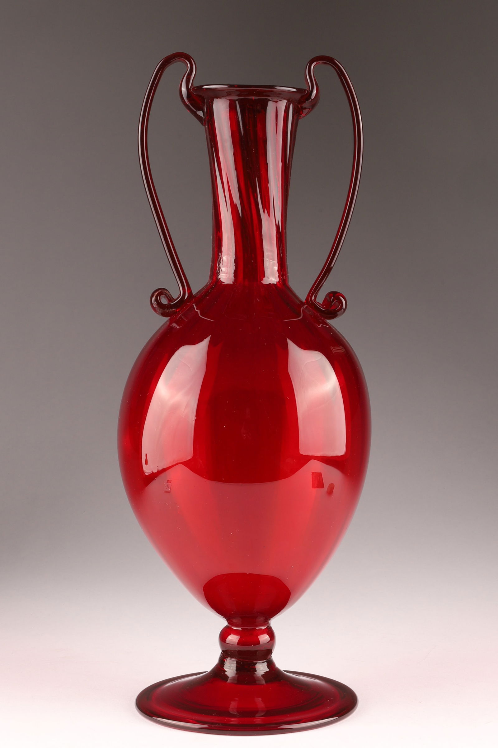 Fratelli Toso Soffiati Crimson Red Glass Vase with Double Handles: Fratelli Toso Soffiati Crimson Red Glass Vase with Applied Double Handles and Costolato / Ribbed Body Venini glassworks, Murano. Measuring 12.25 inches H x 4.5 W.