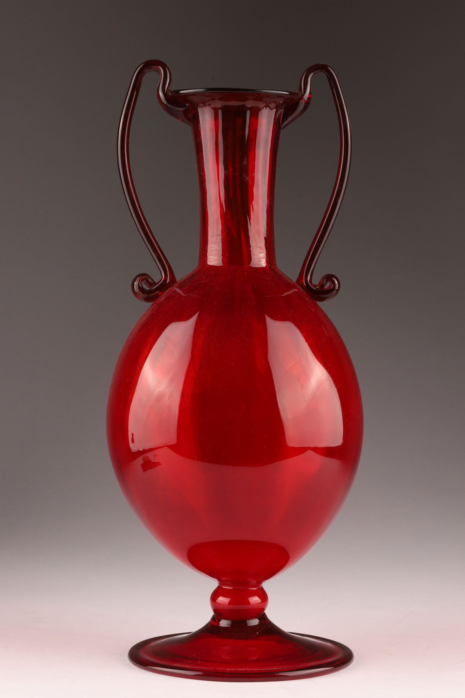 Vittorio Zecchin or Fratelli Toso Soffiati Crimson Red Glass Vase with Double Handles: Vittorio Zecchin or Fratelli Toso Soffiati Crimson Red Glass Vase with Applied Double Handles and Costolato / Ribbed Body Venini glassworks, Murano. Measuring 11.5 inches H x 4.5 W.