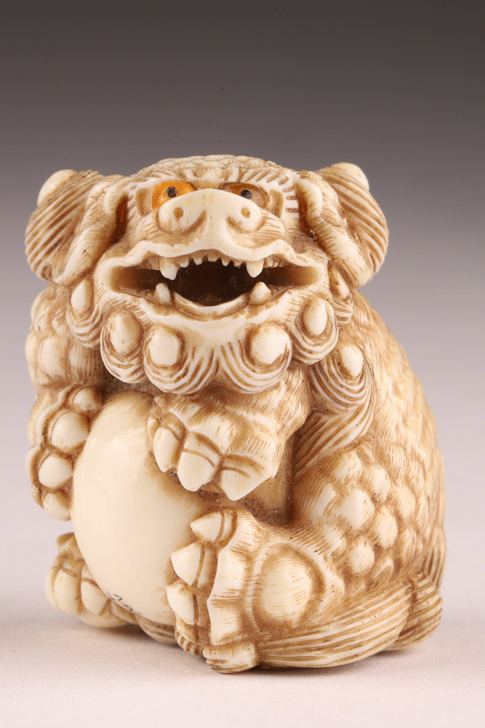 Signed Japanese Netsuke of a Shishi / Buddhist lion Holding a Ball (1 of 7)