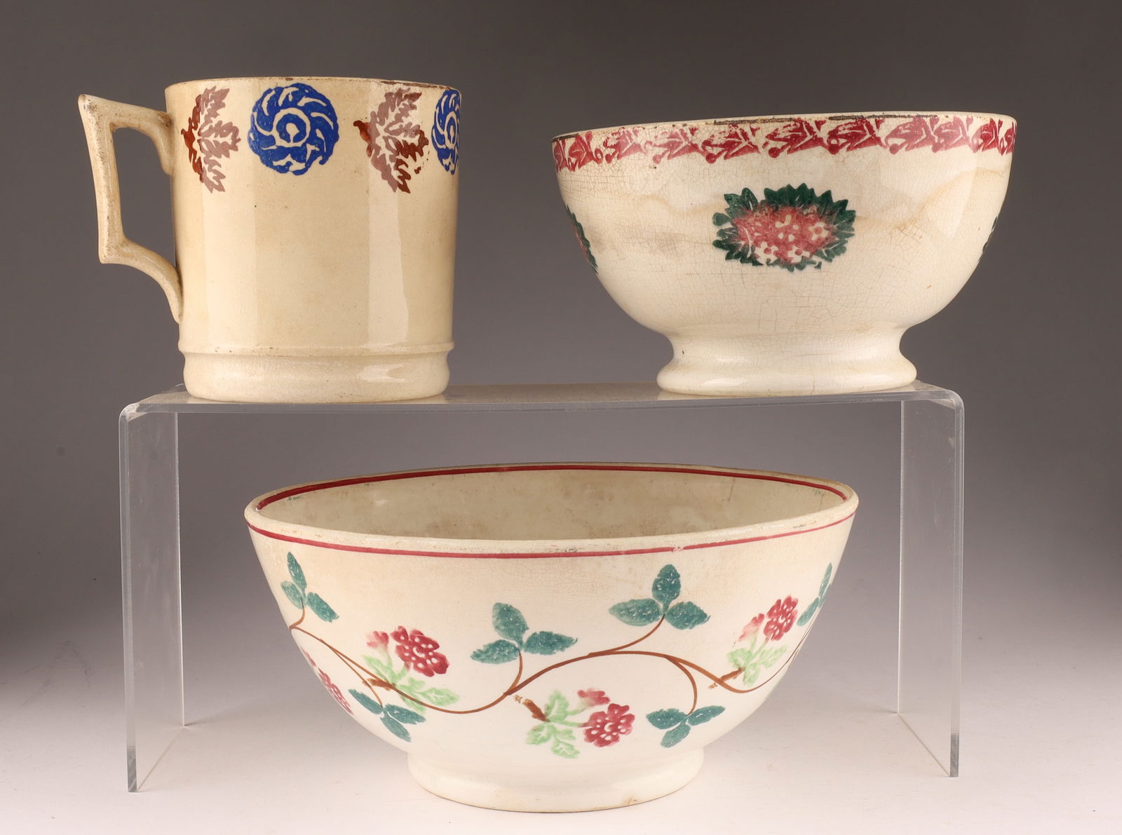 Collection of Antique Spongeware Portneuf and Staffordshire Pottery: Collection of 19th C antique spongeware or sponge-decorated pottery. These items are characterized by their "primitive" or rustic design, created using stencils and sponges to apply patterns. Largest