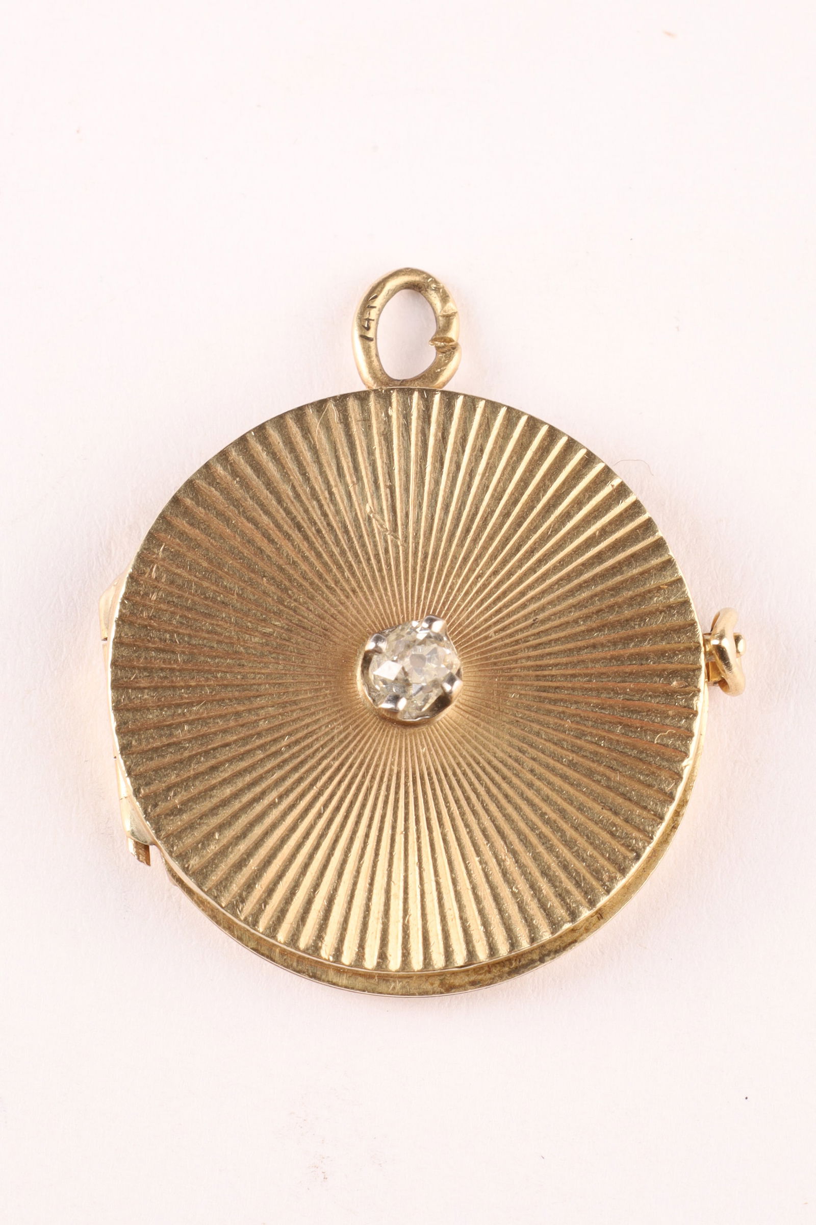 Art Deco 14K Gold and Diamond Pendant Locket: Art Deco yellow 14K gold with Diamond engine turned disc charm pendant locket. With space for four photographs. 10.3 grams, approx. 1 inch diameter. Marked 14K on bale. 
