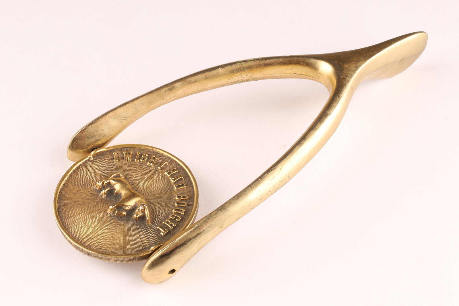 Vintage Ted Arnold Brass Wishbone Paperweight with a Spinner: Vintage Ted Arnold Brass Wishbone Paperweight with a Spinner. The spinner features a bull on one side with the text "I wish I had bought" and a bear on the other with "I wish I h